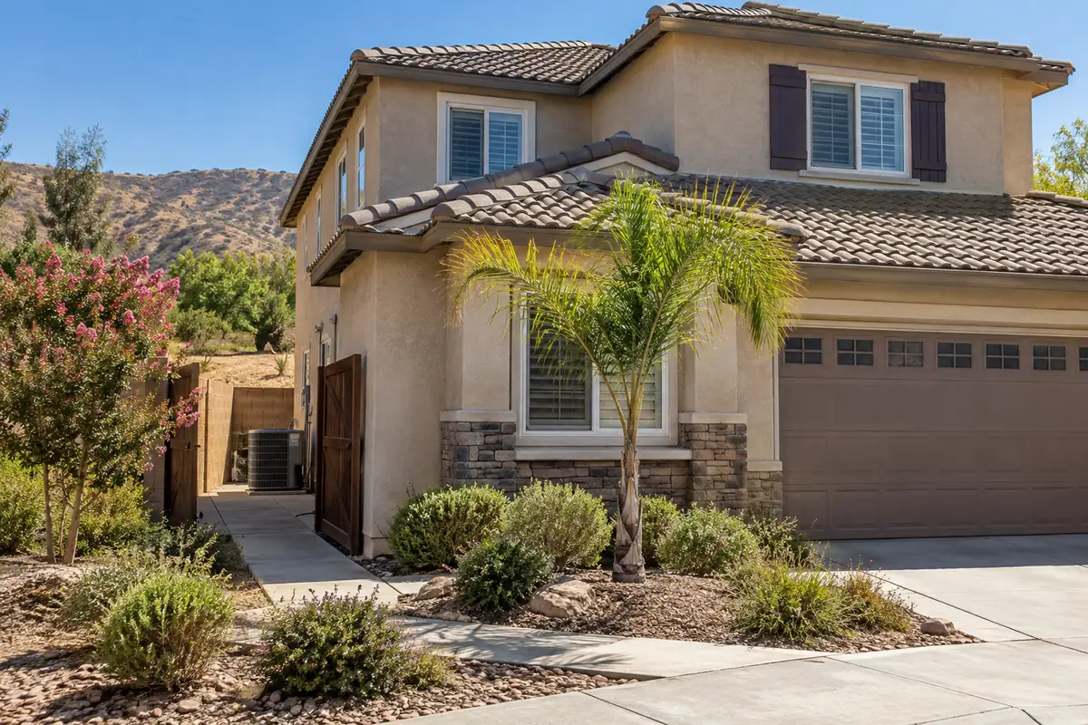Two-story house with a tile roof and desert landscaping, ac maintenance in Las Vegas, NV